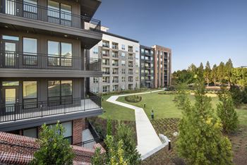 Serene courtyard with outdoor grilling & bistro lighting